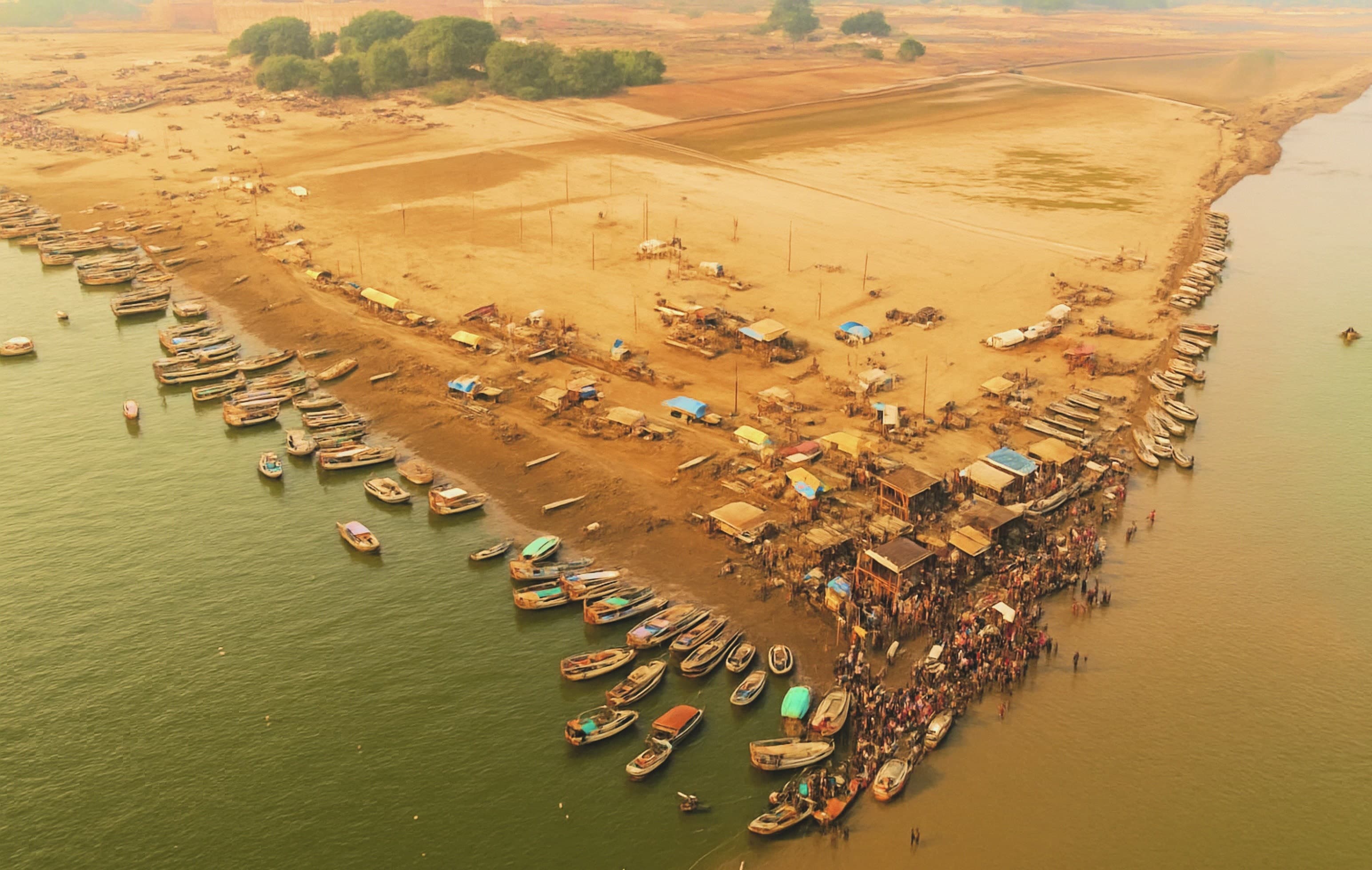 The Ganga at dusk, lamps on her banks